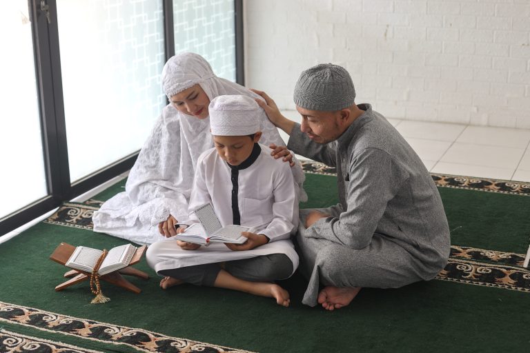 muslim-parents-teaching-al-quran-to-son-at-the-mos-2022-12-15-01-28-20-utc